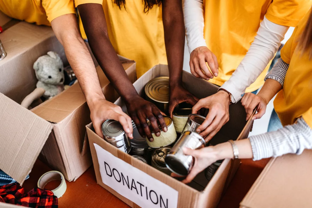 A group of people putting donations into boxes.