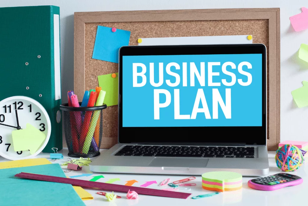 A laptop with the word business plan on it.
